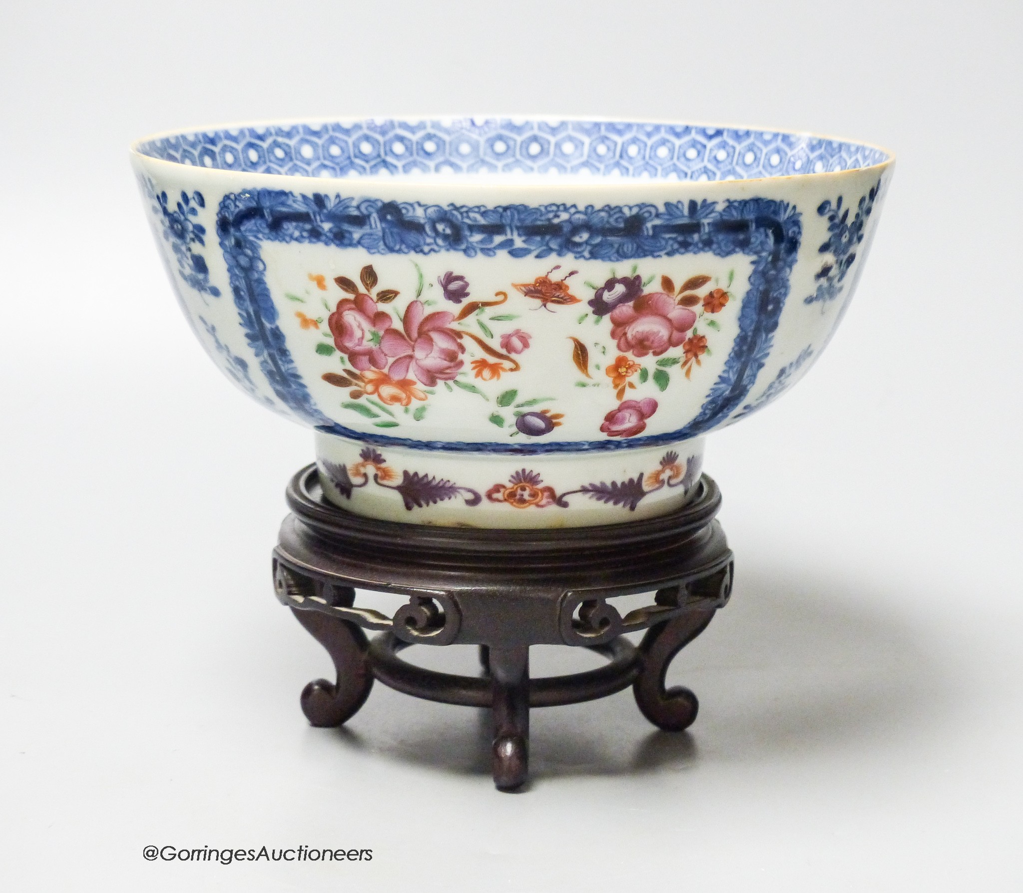 A 18th century Chinese export porcelain footed punch bowl on hardwood stand, diameter 20cm, restored